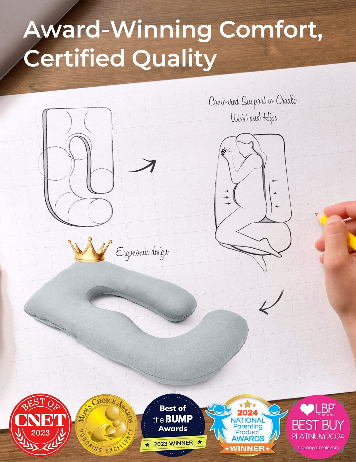 Light grey U-shaped maternity pillow, ergonomic design, supports pregnant women. Award-winning comfort.